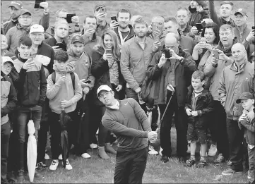  ??  ?? Northern Ireland’s Rory McIlroy plays out of the rough during the second round. — Reuters photo