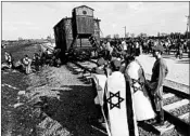  ?? CZAREK SOKOLOWSKI/AP ?? People march on Thursday between former death camps in Auschwitz and Birkenau, in Oswiecim, Poland. A study says many Americans cannot identify what Auschwitz was.