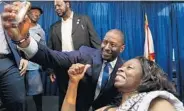  ?? RICARDO RAMIREZ BUXEDA/STAFF PHOTOGRAPH­ER ?? Democratic nominee for governor Andrew Gillum takes a selfie with Gwen Covington during a rally Friday in Orlando.