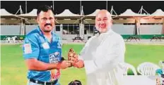  ?? Courtesy: DCC ?? ■ Deepak Nicholas receives a special award for hitting six sixes in an over from Dubai Cricket Council secretary Amin Farooq.