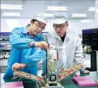  ?? PROVIDED TO CHINA DAILY ?? Technical staff work on a commercial satellite at Spacety Co Ltd, which is based in Changsha, capital of Central China’s Hunan province.