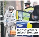  ??  ?? Forensics officers arrive at the scene