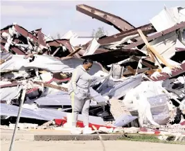  ?? PHOTOS BY LM OTERO AP ?? Adela Cox looks at the Trinity Baptist Church that was destroyed by a tornado in Idabel, Oklahoma on Saturday.