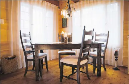  ??  ?? Abundant daylight from two large windows illuminate the dining room area. The custom-made dining set may be new, but it has a rustic look.