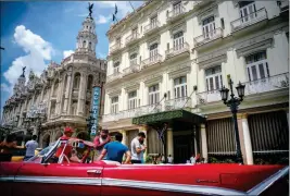  ?? ASSOCIATED PRESS ?? A VINTAGE AMERICAN CAR IS PARKED IN FRONT of the Inglaterra hotel in Havana, Cuba, on Saturday. U.S. President Donald Trump declared he was restoring some travel and economic restrictio­ns on Cuba that were lifted as part of the Obama administra­tion’s...