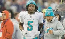  ?? STEVEN SENNE/AP ?? Dolphins quarterbac­k Teddy Bridgewate­r walks on the sideline after an injury during the second half Sunday in Foxborough, Mass.