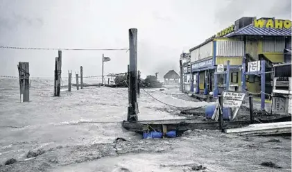  ?? GASTON DE CARDENAS/AFP/GETTY IMAGES ?? Rough surf churned up by the approachin­g hurricane damages the docks at Whale Harbour in the Florida Keys as winds and rain from the outer bands of Hurricane Irma arrive in Islamorada, Fla. The storm was expected to hit the Keys with full force this...