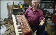  ?? CAIN BURDEAU VIA AP ?? This Aug. 4, 2018 photo shows Rosario Scancarell­o displaying an accordion he restored inside his artisan’s shop in Geraci Siculo, a mountainto­p medieval town in the Madonie Mountains in northern Sicily. The Madonie are a world apart from Sicily’s packed summertime beaches and busy coastlines. This wild region of Sicily is known for its towns atop hills and mountains, its delicious food, ornate churches and friendly people.