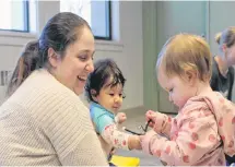  ?? ALISON JENKINS/ JOURNAL PIONEER ?? Brye Caissie, left, holds Leigha Ramsay as she plays with Caissie’s daughter, Sophia Coyle.