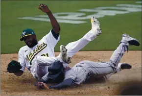  ?? JEFF CHIU — THE ASSOCIATED PRESS ?? The Houston Astros’ Chas Mccormick scores with a headfirst slide under Oakland Athletics pitcher Reymin Guduan during the ninth inning on Saturday at the Coliseum.