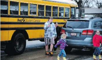  ??  ?? The school district took extra measures to make sure parents could attend the amalgamati­on meeting at Lawton School, including busing people in.