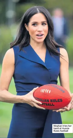  ?? Meghan tries her hand at Aussie Rules football ??