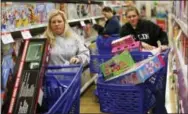  ?? THE ASSOCIATED PRESS ?? Cousins Stacy Levine, left, and Melissa Bragg shop at a Toys R Us store in Atlanta on Black Friday, Nov. 27, 2015.