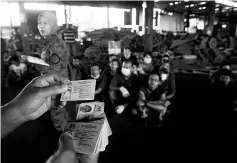  ?? - Bernama photo ?? An Immigratio­n enforcemen­t personnel scanning through the ‘Enforcemen­t Card’ or E-Card of foreign workers rounded up in the E-Card Special Ops at a factory premises in Bukit Mertajam yesterday.