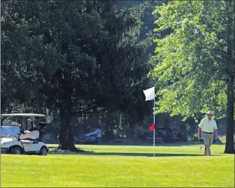  ??  ?? John Green approaches the ninth hole at Wyandot Golf Course in Centerburg during a recent outing with the Westervill­e Senior Center.