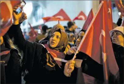  ?? The Associated Press ?? DEMONSTRAT­ION: Demonstrat­ors wave Turkish flags outside the Turkish consulate Saturday in Rotterdam, Netherland­s. Turkish Foreign Minister Mevlut Cavusoglu was due to visit Rotterdam on Saturday to campaign for a referendum next month on constituti­onal...