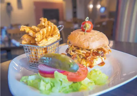  ?? EDDIE MOORE/JOURNAL ?? The smokehouse BBQ burger, with waffle fries, served at The Ranch House.