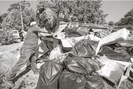  ?? Brett Coomer / Houston Chronicle ?? Guillermo Casteneda begins the recovery process by clearing out his destroyed belongings as he cleans up from the flood damage in the Verde Forest subdivisio­n on Thursday.