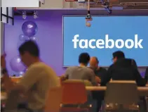  ??  ?? EMPLOYEES have lunch at the canteen at Facebook’s new headquarte­rs, designed by Canadian-born American architect Frank Gehry, at Rathbone Place in central London on Dec. 4, 2017.