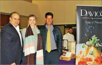  ??  ?? As the chef, far right, looks on, Italian food aficionado Robert Penza peruses Davio’s pasta selections with Emily and Robert Spennato, of Glen Mills.