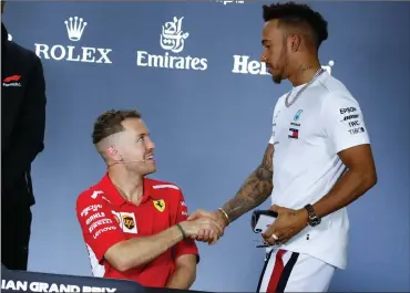  ?? Picture: EPA-EFE, DIEGO AZUBEL ?? I’LL SEE YOU ON THE TRACK, MY FRIEND: Sebastian Vettel and Lewis Hamilton greet at a press conference in Melbourne yesterday.