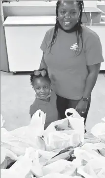  ?? Submitted Photo ?? Forrest City Councilman Jason Evansingst­on coordinate­d an effort between Zenenvirot­ech, Inc., and the St. Francis County Food Pantry to secure nutrient dense fruits and vegetables for senior citizens as a part of its fresh pantry project. Recently, Andrea White, co-owner of Sunlight Farm, and her daughter delivered fresh produce to the Pantry. Fresh pantry is an initiative that works with local farmers and community food programs to reduce food insecurity and hunger in a healthy way. Sunlight Farm grew and harvested the zucchini, corn, cucumbers, peppers, and tomatoes that were in the bags. They also raise chickens and provided a half dozen eggs for each bag.