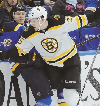  ?? STaff phoTo by maTT wesT ?? HARD KNOCK: Bruins defenseman Brandon Carlo checks the Blues’ Dmitrij Jaskin during last night’s game in St. Louis.