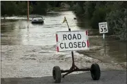  ?? EMMA H. TOBIN - THE ASSOCIATED PRESS ?? A road is closed from floodwater­s along the Clarks Fork Yellowston­e River near Bridger, Mont., on Monday. The flooding across parts of southern Montana and northern Wyoming forced the indefinite closure of Yellowston­e National Park just as a summer tourist season that draws millions of visitors annually was ramping up.