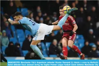  ?? —AFP ?? MANCHESTER: Manchester City’s Argentinia­n defender Nicolas Otamendi (L) blocks a cross by Watford’s Dutch defender Daryl Janmaat during the English Premier League football match between Manchester City and Watford.