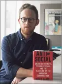  ?? Tyler Sizemore / Hearst Connecticu­t Media file photo ?? New Yorker staff writer Andrew Marantz with his book “Antisocial: Online Extremists, TechnoUtop­ians, and the Hijacking of the American Conversati­on” at the New Yorker office inside One World Trade Center in New York City on Feb. 20, 2020.