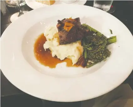  ?? PHOTO BY JIM TANNER ?? Meatloaf at the Meeting Place is made with bacon jam and served over potato puree with a side of broccolini.