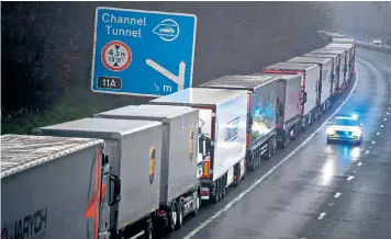  ??  ?? Lorries line the M20 motorway in Kent after France announced it will not accept any passengers arriving from the UK