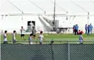  ??  ?? Immigrant children play Monday outside a former Job Corps site that now houses them in Homestead, Fla. It is not know if the children crossed the border as unaccompan­ied minors or were separated from family members. WILFREDO LEE/AP