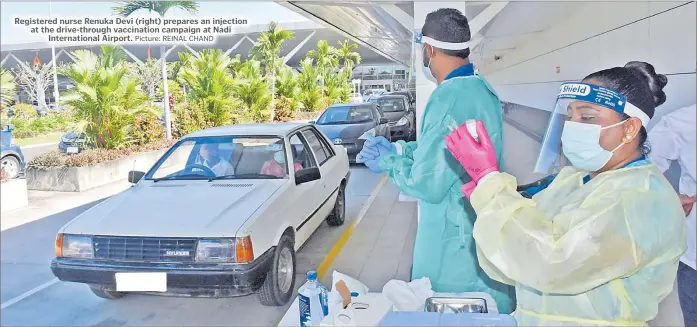  ?? Picture: REINAL CHAND ?? Registered nurse Renuka Devi (right) prepares an injection at the drive-through vaccinatio­n campaign at Nadi Internatio­nal Airport.