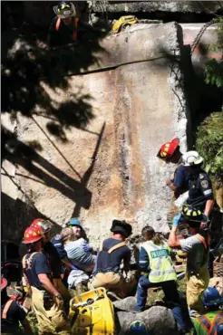  ?? BARRY GRAY, THE HAMILTON SPECTATOR ?? Rescuers work to free the worker trapped under a concrete slab on Progreston Road.