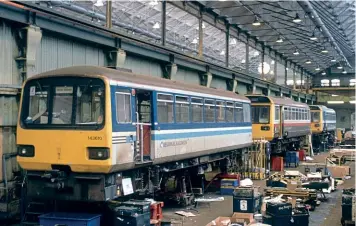  ??  ?? ‘Pacers' Nos. 143610 (Regional Railways livery), 142014 (Greater Manchester livery), and one other unidentifi­ed ‘142' (Provincial Services blue) are pictured having upgrade work at Doncaster Works in March 1995.