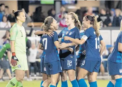  ?? KYLE TERADA/USA TODAY SPORTS ?? is congratula­ted after scoring against Chile goalkeeper Christiane Endler during an internatio­nal friendly.