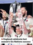  ??  ?? > England celebrate last season’s Six Nations success