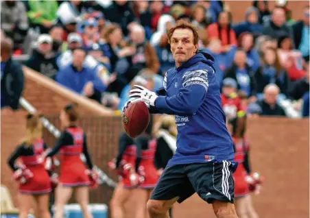  ?? Jerry Baker ?? Doug Flutie targets a receiver during first quarter of the Celebrity Flag Football Challenge on Saturday at Rhodes Stadium in Katy. One young fan yelled at Flutie, “If I don’t get your signature, I’m going to walk away crying!” She got the autograph.