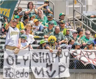  ?? Douglas Stringer / Icon Sportswire via Getty Images ?? A’s fans get ready for a game against the Mariners at the Coliseum in June. The “A’s Access” plan, essentiall­y a fullseason subscripti­on to the stadium, has been a hit with fans.