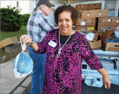  ?? PHOTOS BY PETE BANNAN — DIGITAL FIRST MEDIA ?? Mount Carmel Church’s Joan Baxter holds one of the turkeys that will go in Thanksgivi­ng baskets, which will be given out to area residents in need Saturday.