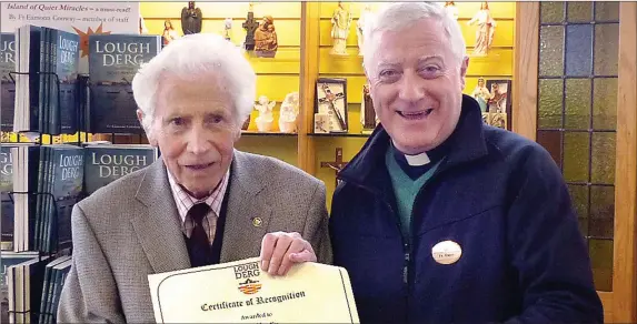  ??  ?? Fr Owen McEneaney presenting a certificat­e to Pat Martin recognisin­g him as the oldest pilgrim to make the journey to Lough Derg in 2017.