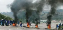  ?? (Rogan Ward/Reuters) ?? SUPPORTERS OF former South African President Jacob Zuma block a freeway with burning tires during a protest in Peacevale, South Africa on Friday.