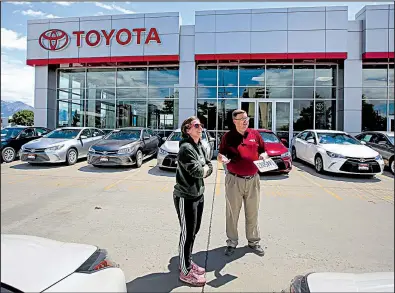  ?? AP/RICK BOWMER ?? A shopper visits with a salesman for Mark Miller Toyota in Salt Lake City, in June. Toyota’s sales of new cars and trucks rose 3.6 percent in July, bucking the trend of lower sales for U.S. automakers.