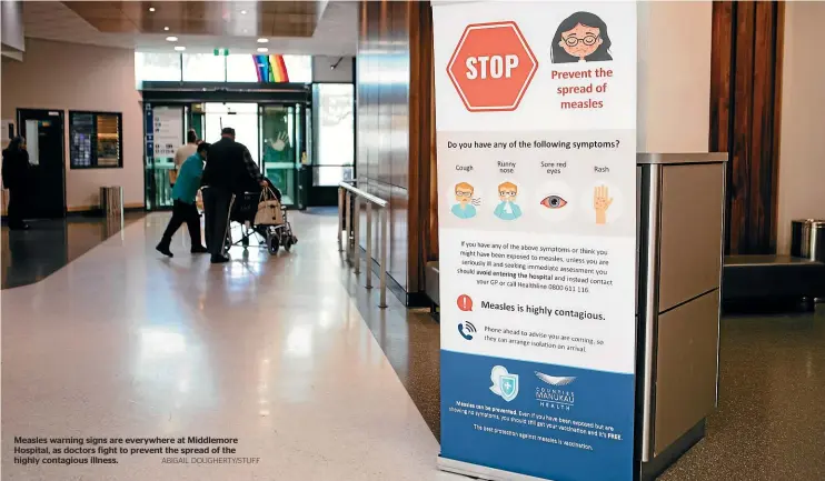  ?? ABIGAIL DOUGHERTY/STUFF ?? Measles warning signs are everywhere at Middlemore Hospital, as doctors fight to prevent the spread of the highly contagious illness.