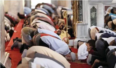  ??  ?? AMONG others, a Syrian boy, name not given, prays at Fatih Mosque in Istanbul. Syrians say Turkey has been detaining and forcing some Syrian refugees to return to their country this month. The expulsions reflect increasing anti-refugee sentiment in Turkey, which once opened its doors to millions of Syrians fleeing their country’s civil war. | AP