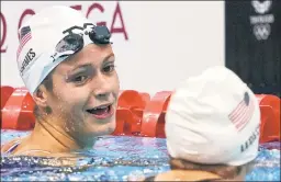  ?? AP (2) ?? TEEN SCENE: Katie Grimes, 15, talks with Katie Ledecky after they finished 1-2 in qualifying Thursday for Friday’s final of the 800-meter freestyle.