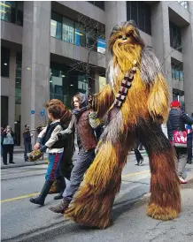  ??  ?? The Calgary Comic and Entertainm­ent Expo kicked off with the Parade of Wonders down 8th Avenue on Friday. Thousands of people marched and lined the streets to watch the pageantry and costumed characters.