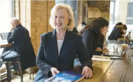  ?? BRIAN CASSELLA/CHICAGO TRIBUNE ?? Connie Fairbanks with her new book,“Chicago’s West Loop, Then and Now: People, Businesses, Buildings,” on Oct. 24 at Ground Up Coffee & Bites.