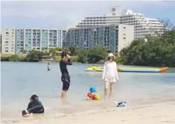  ??  ?? GUAM: This photo shows tourists on a beach in Guam’s capital Hagatna.—AFP